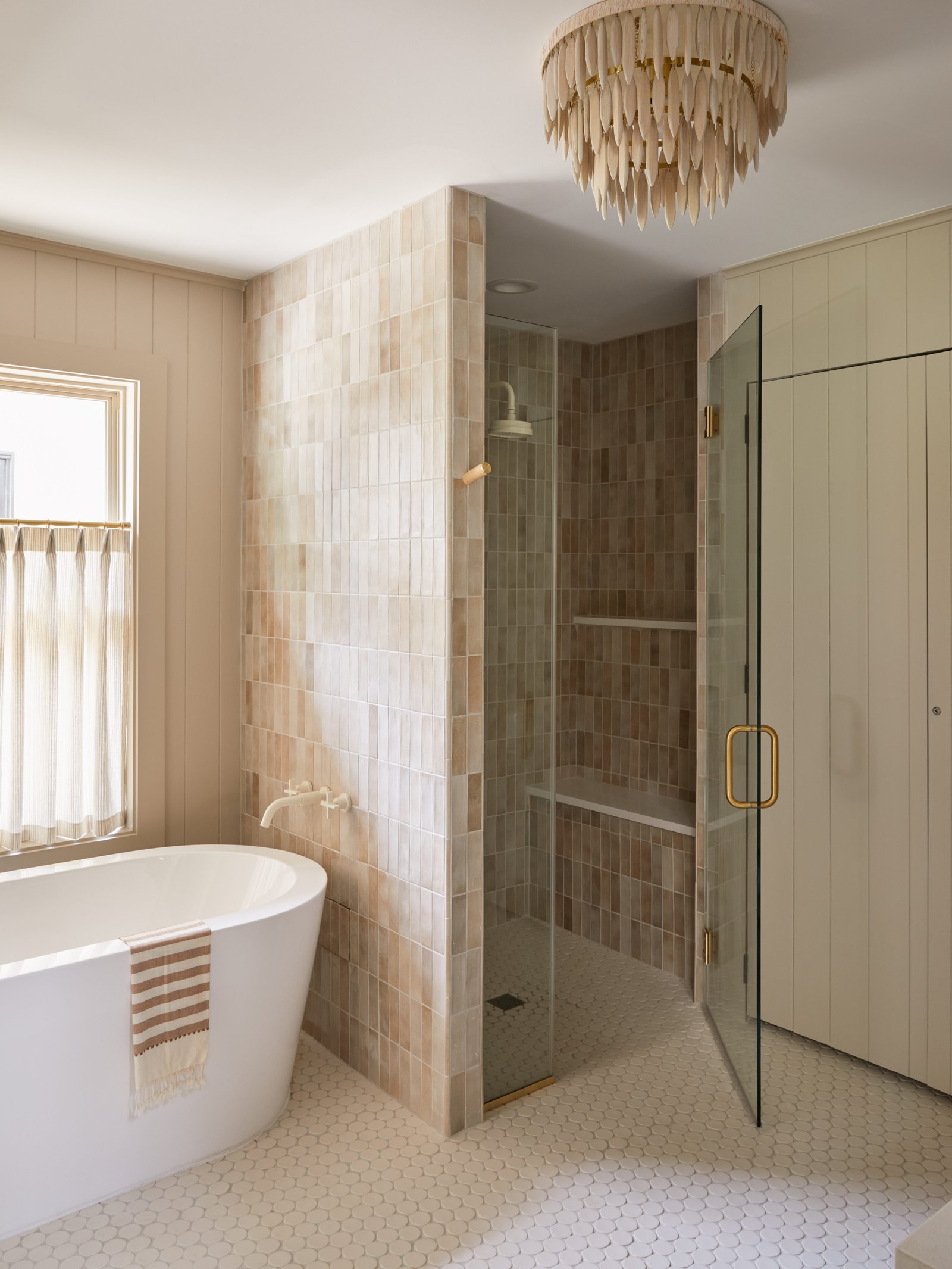 bathtub next to the shower wall