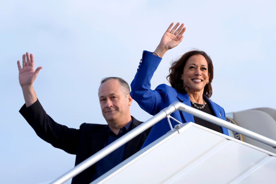 Democratic presidential nominee Vice President Kamala Harris, right, and second lieutenant Doug Emhoff wave as they board Air Force Two at Pittsburgh International Airport, Sunday, Aug. 18, 2024, in Pittsburgh. (AP Photo/Julia Nikhinson)
