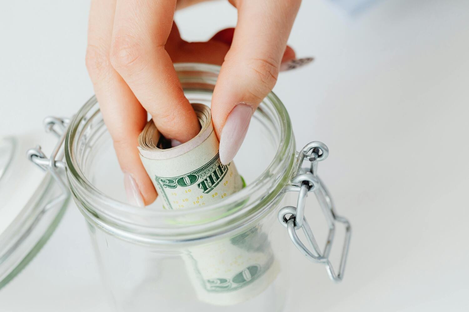 putting money in a jar, emergency fund