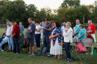 People are waiting in prayer guard that is held against violence in Burton